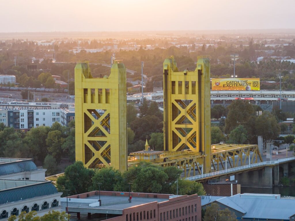 Golden bridge towers against a hazy sunset sky
