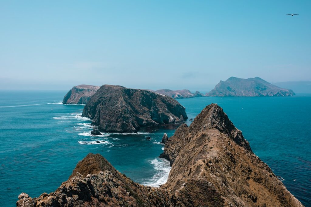 brown rock formation on sea during daytime