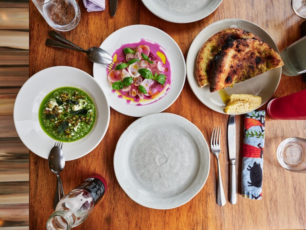 Overhead view of a table set with gourmet dishes